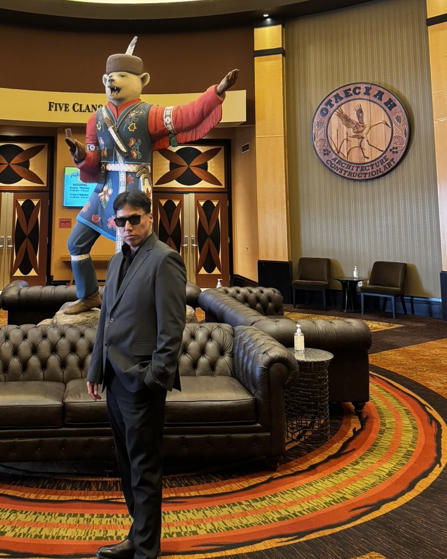 Josh Tucker in a dark suit and sunglasses